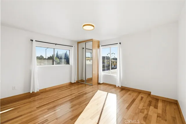 a view of a room with wooden floor and a window