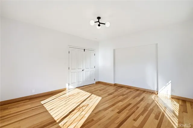a view of a room with wooden floor