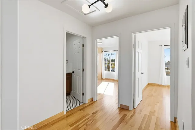 a view of a room with wooden floor and a bathroom