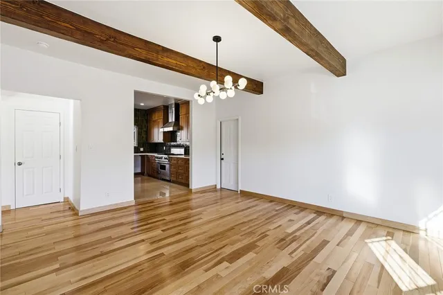 a view of a room with wooden floor
