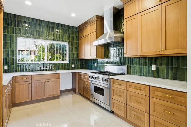 a kitchen with stainless steel appliances granite countertop a stove a sink and a refrigerator