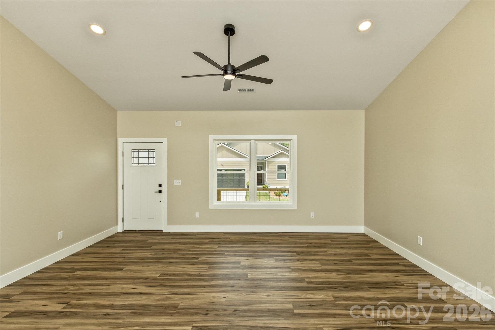 112 Peyton Elaine Road Clyde, NC 28721 - Photo 5 of 35 a view of an empty room with wooden floor and a window