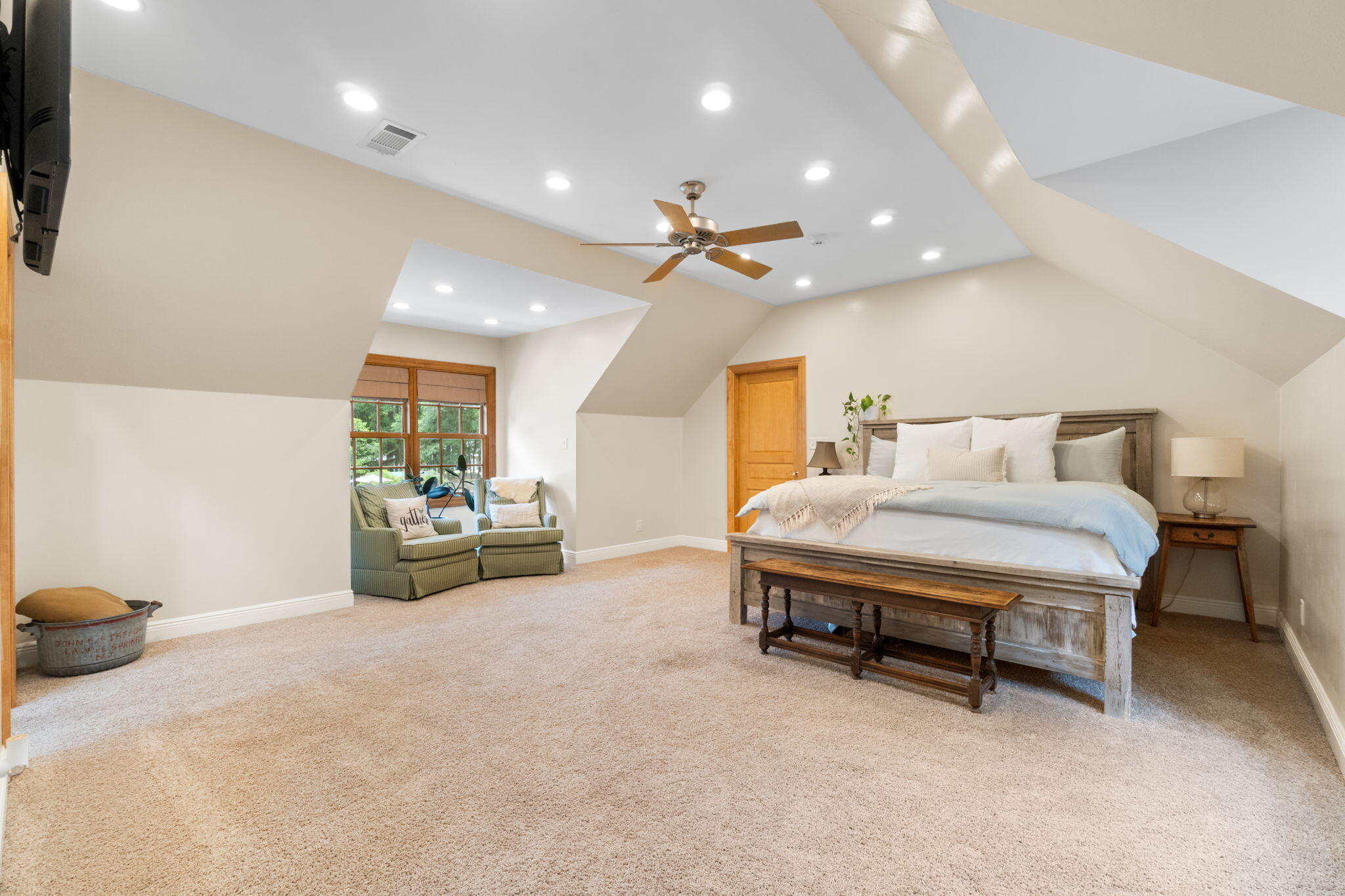 5750 Windham Road Milton, FL 32570 - Photo 14 of 77 a spacious bedroom with a bed and a chandelier