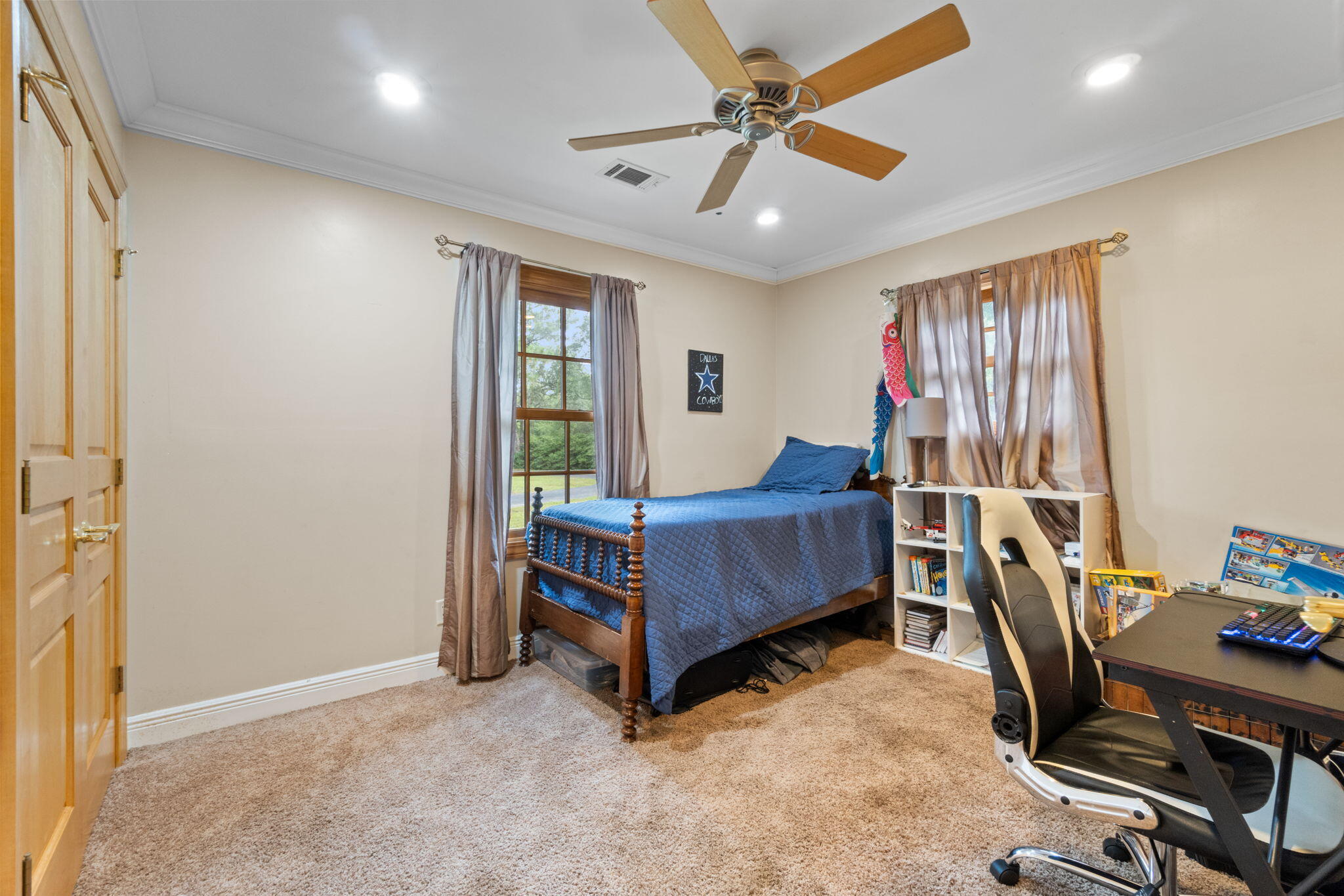 5750 Windham Road Milton, FL 32570 - Photo 22 of 77 a bedroom with a bed and a chandelier
