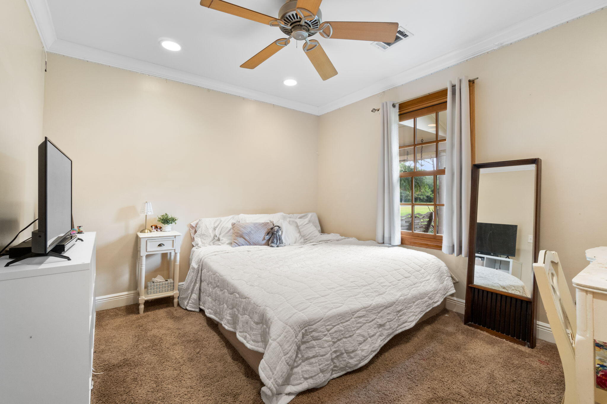5750 Windham Road Milton, FL 32570 - Photo 28 of 77 a bedroom with a bed and a flat tv screen on dresser