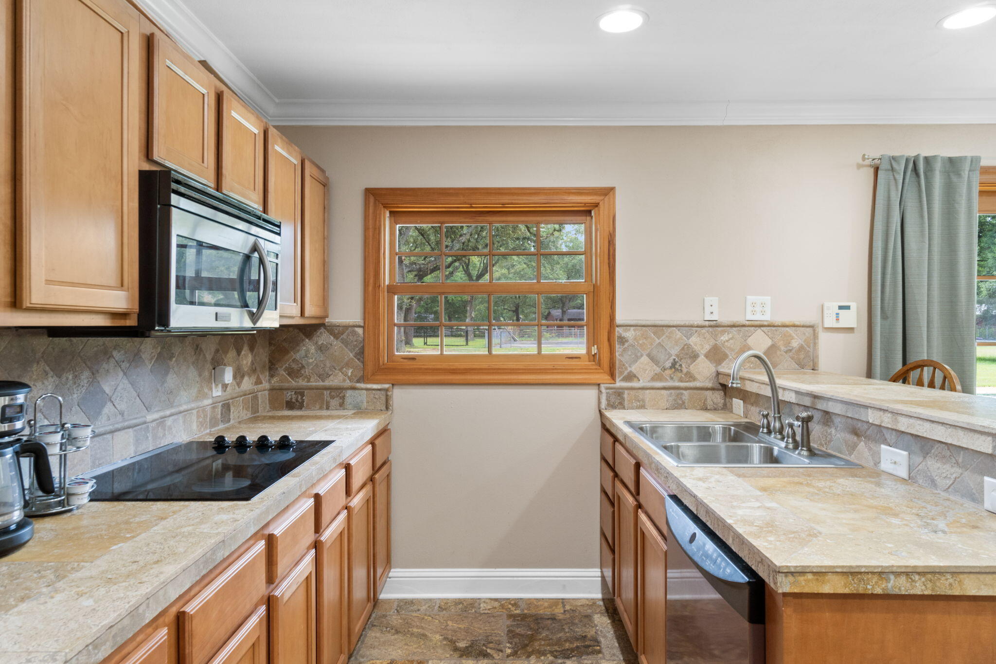 5750 Windham Road Milton, FL 32570 - Photo 51 of 77 a kitchen with stainless steel appliances granite countertop a sink stove and cabinets