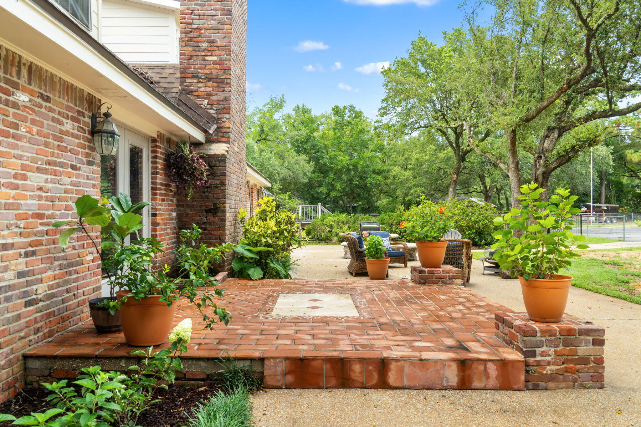 5750 Windham Road Milton, FL 32570 - Photo 61 of 77 a view of a house with sitting area and potted plants