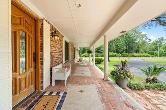 a living room with furniture a flat screen tv and a ceiling fan