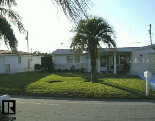 1555 Alert Street Holiday, FL 34690 - Photo 1 of 1 a front view of a house with garden