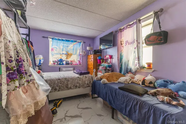 an empty room with wooden floor cabinet and windows