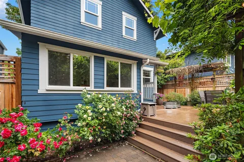 a flower garden is sitting in front of a house