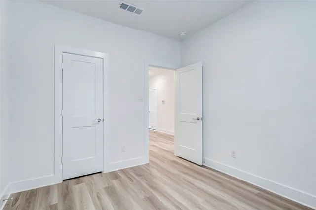 a view of an empty room and wooden floor
