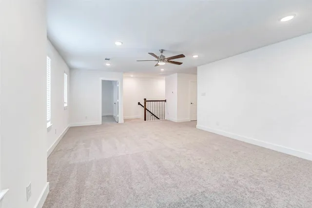 a view of a livingroom with a ceiling fan and window