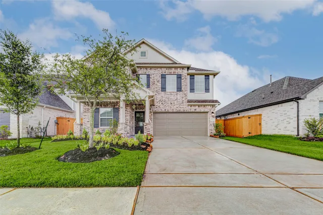 a front view of house with yard and green space