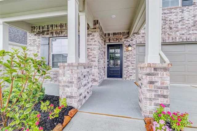 a front view of a house with an outdoor space and seating
