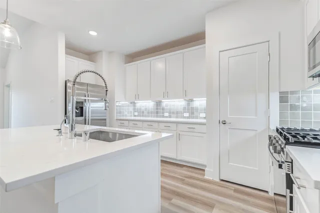 a kitchen with a sink cabinets and window