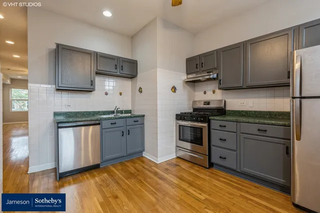 a kitchen with stainless steel appliances granite countertop a stove a sink dishwasher and a refrigerator