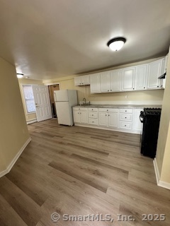 a kitchen with a cabinets and wooden floor