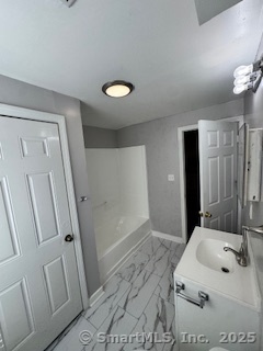 92 West Main Street Vernon, CT 06066 - Photo 11 of 14 a bathroom with sink and mirror