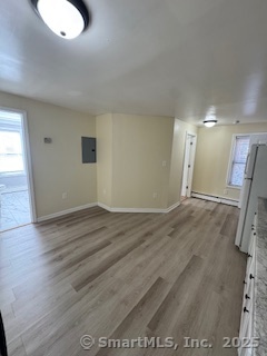 92 West Main Street Vernon, CT 06066 - Photo 2 of 14 an empty room with wooden floor and windows
