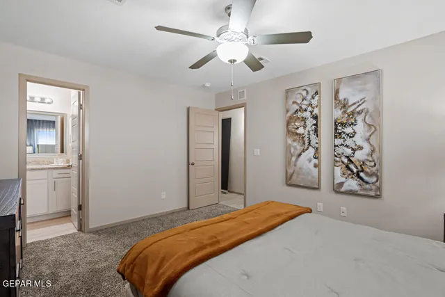 a bedroom with a large bed and a window