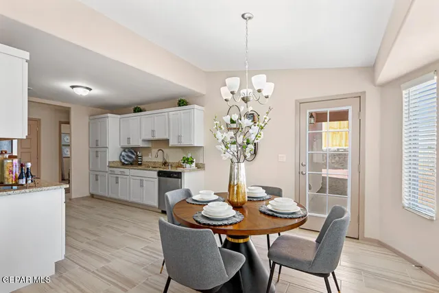 a dining room filled chandelier and wooden floor
