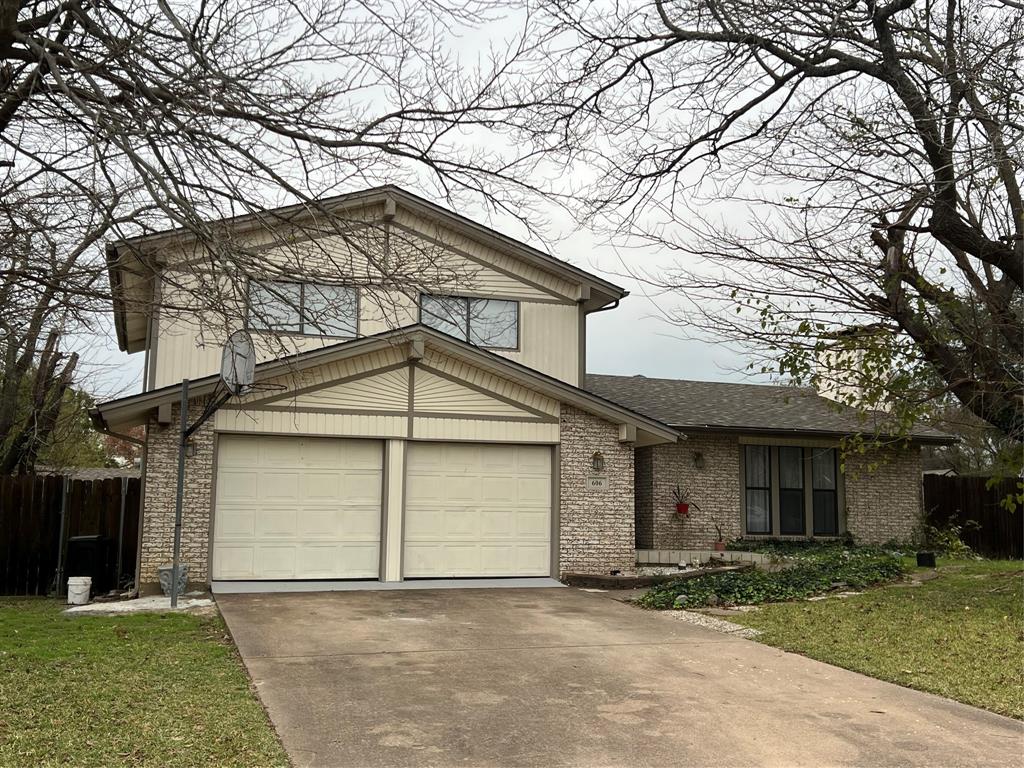 606 Madison Court Duncanville, TX 75137 - Photo 1 of 1 a front view of a house with a yard and garage