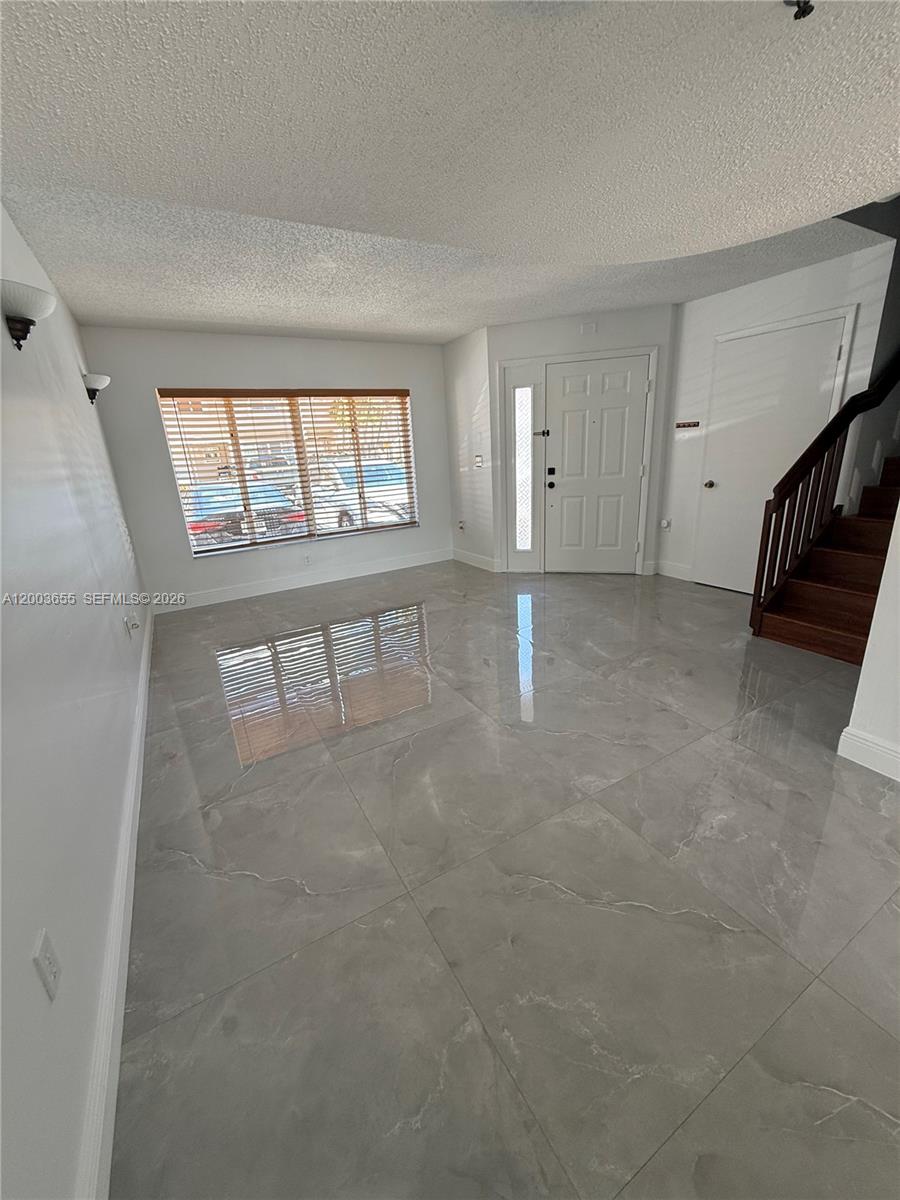 203 Riviera Circle, Unit 203 Weston, FL 33326 - Photo 15 of 30 wooden floor in an empty room with a window