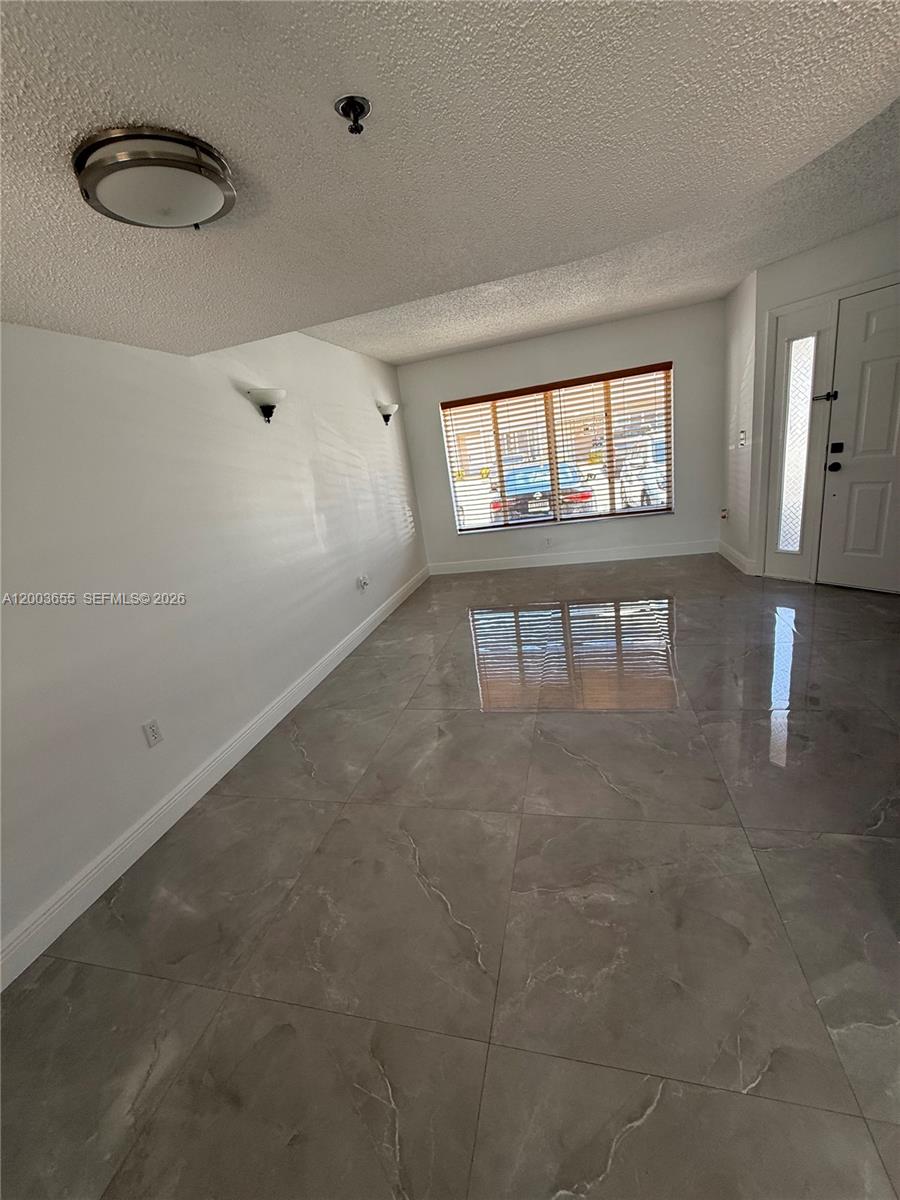 203 Riviera Circle, Unit 203 Weston, FL 33326 - Photo 18 of 30 a view of an empty room with a window