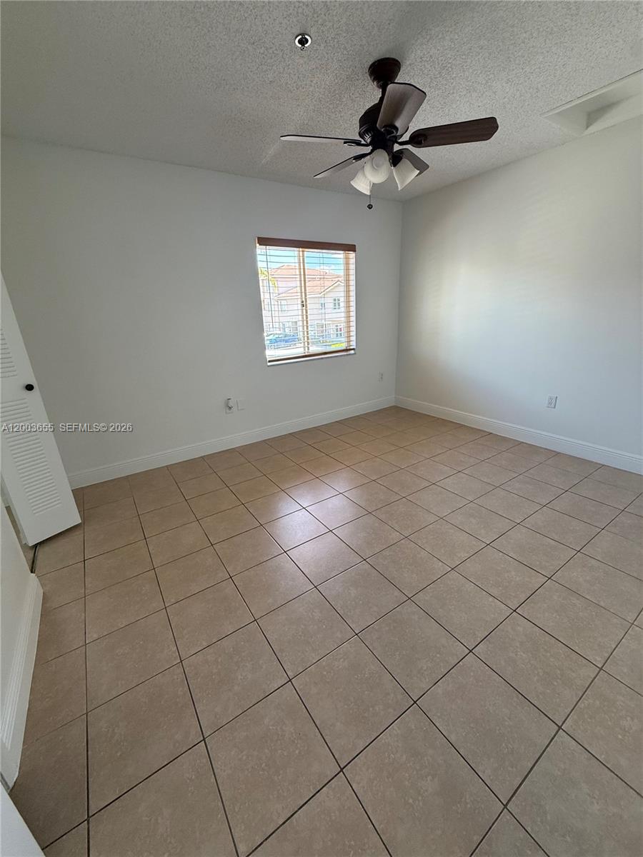 203 Riviera Circle, Unit 203 Weston, FL 33326 - Photo 22 of 30 a view of an empty room and window fan
