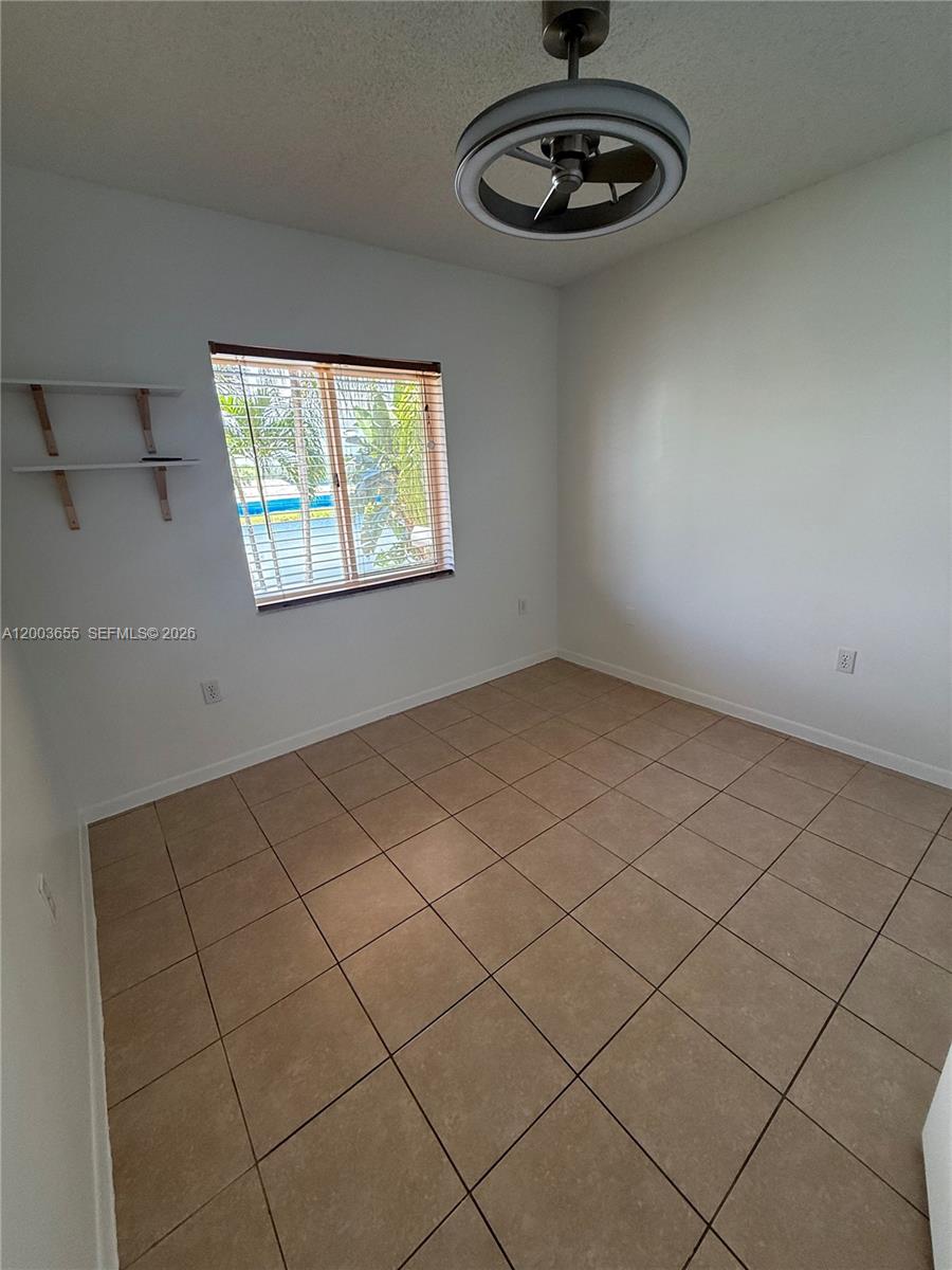 203 Riviera Circle, Unit 203 Weston, FL 33326 - Photo 24 of 30 a view of a room with racks on the wall