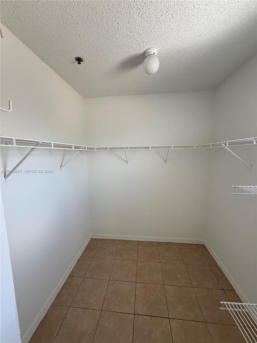 203 Riviera Circle, Unit 203 Weston, FL 33326 - Photo 25 of 30 a view of a room with racks on the wall