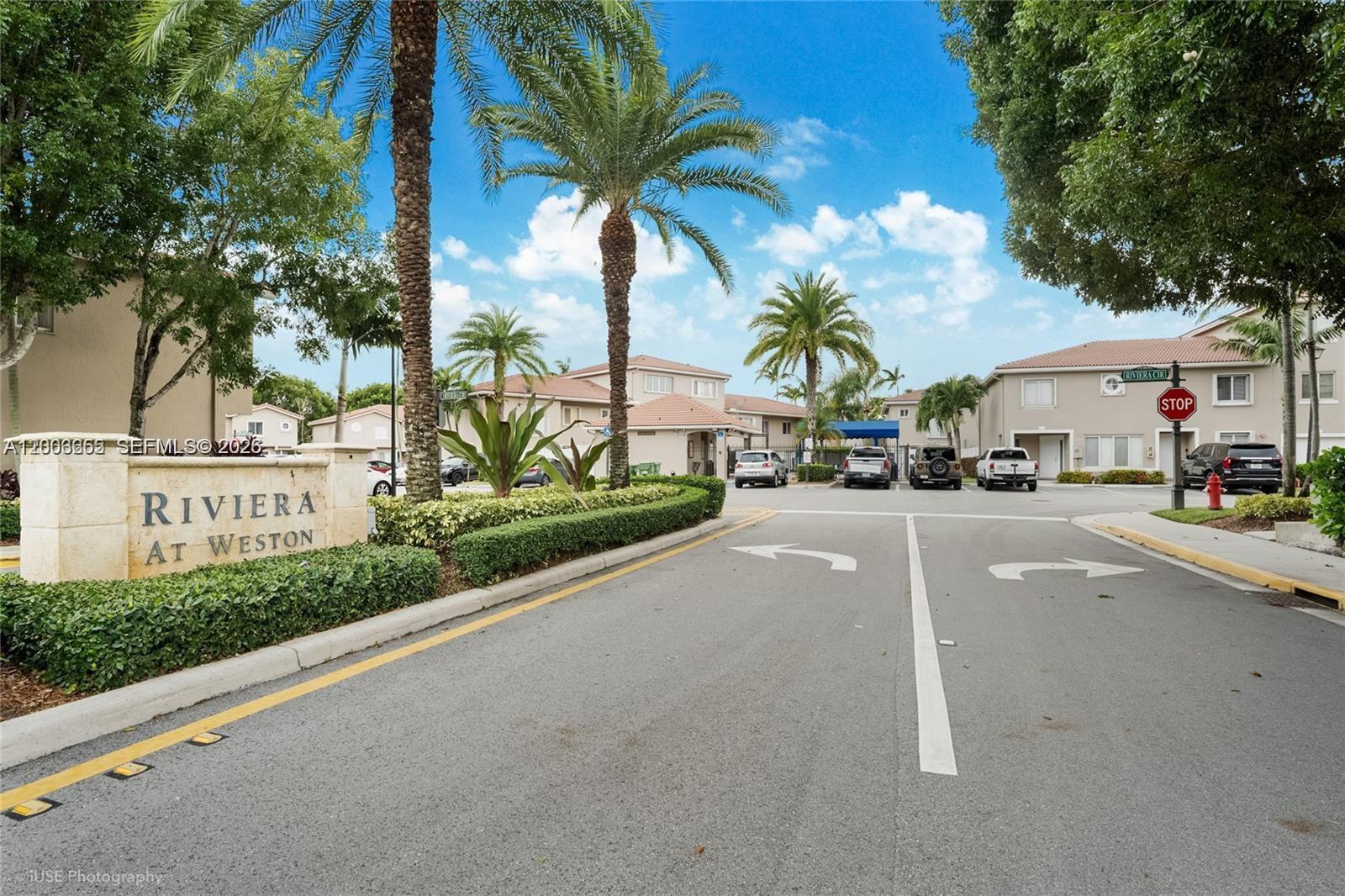 203 Riviera Circle, Unit 203 Weston, FL 33326 - Photo 26 of 30 a view of street with a cars and palm trees