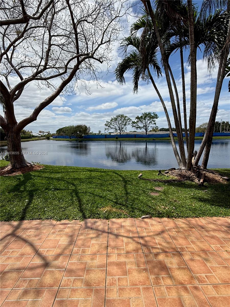 203 Riviera Circle, Unit 203 Weston, FL 33326 - Photo 27 of 30 a view of a lake with a big yard and large trees