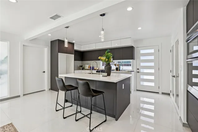 a kitchen with stainless steel appliances kitchen island granite countertop a sink and cabinets