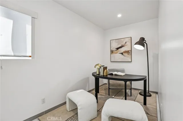 a view of a room with furniture and wooden floor