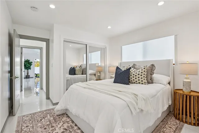 a bed room with a bed and a mirror