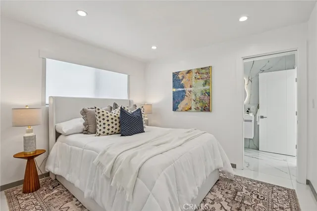 a bedroom with bed and a night stand