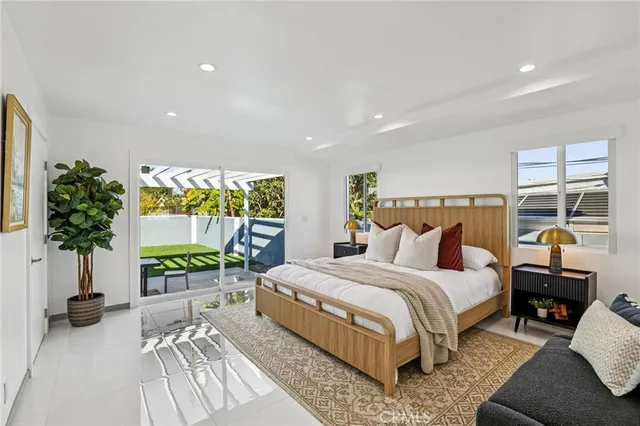 a bedroom with a bed and a large window