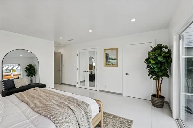 a bedroom with furniture and a potted plant