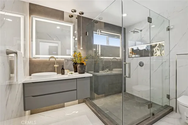 a bathroom with a shower sink and mirror