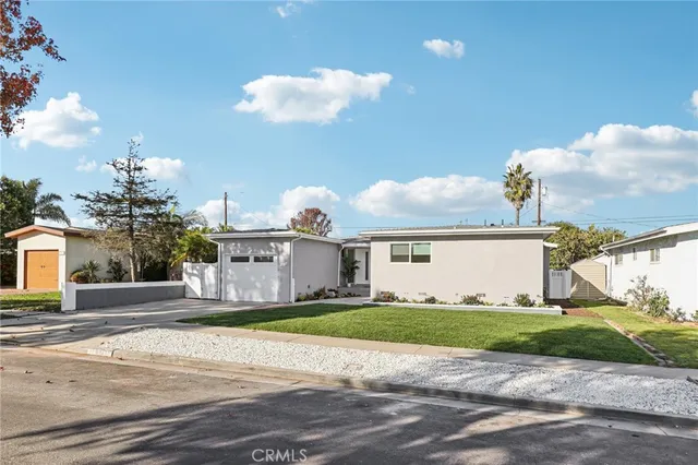 a view of a house with a yard and a fountain