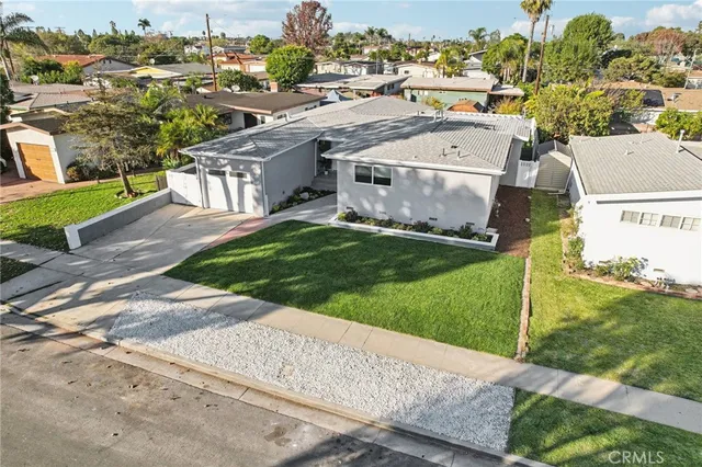 an aerial view of a house with a yard and lake view