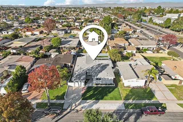 an aerial view of a house with a swimming pool outdoor seating and yard