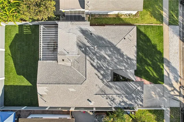 an aerial view of a house with a yard