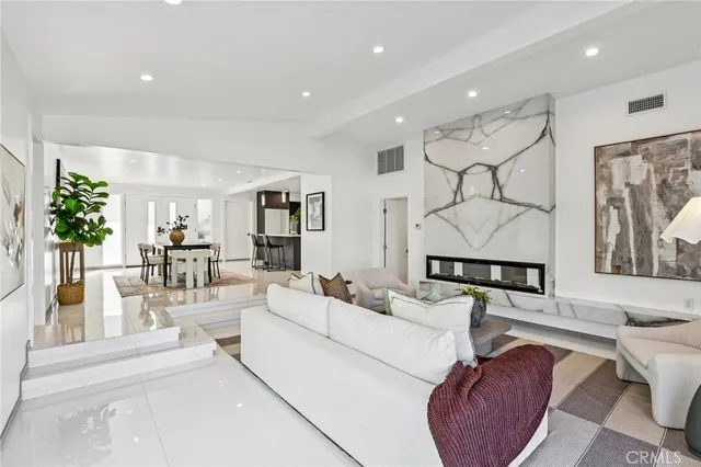 a living room with furniture a rug and white walls