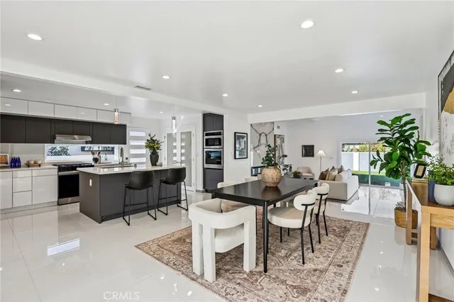 a kitchen with a table and chairs in it