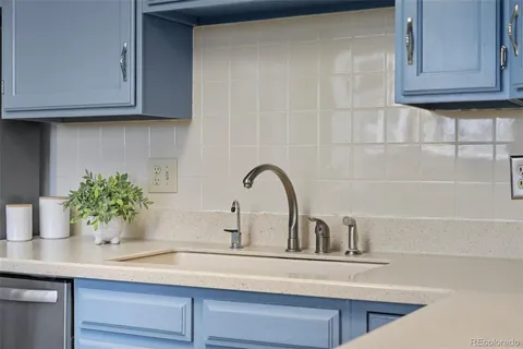 a kitchen with a sink and cabinets