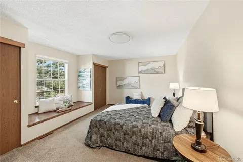 a bedroom with a bed lamps and window
