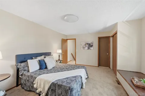 a bedroom with a bed and a lamp with window